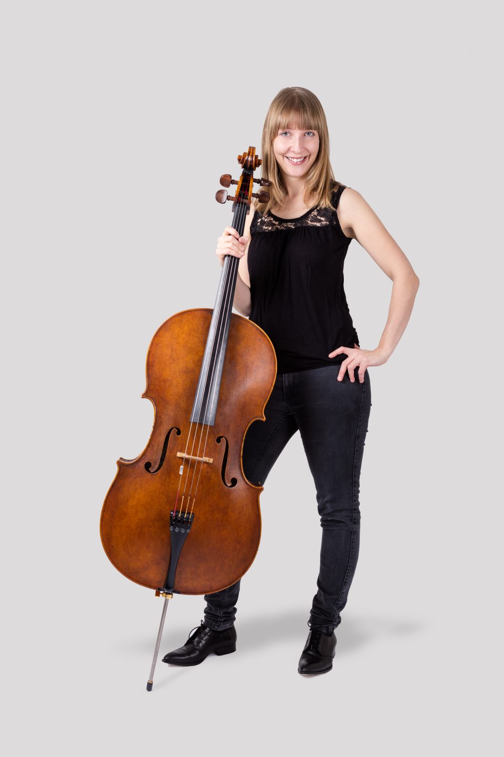 Isabel Gehweiler in casual outfit with cello on side